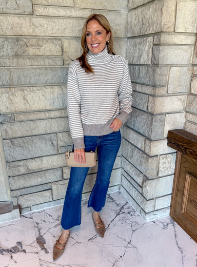 Taupe and cream striped turtleneck sweater with button on left shoulder