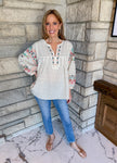 Natural color boho top with colorful embroidery along front and sleeves