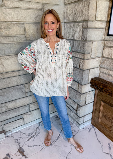 Natural color boho top with colorful embroidery along front and sleeves