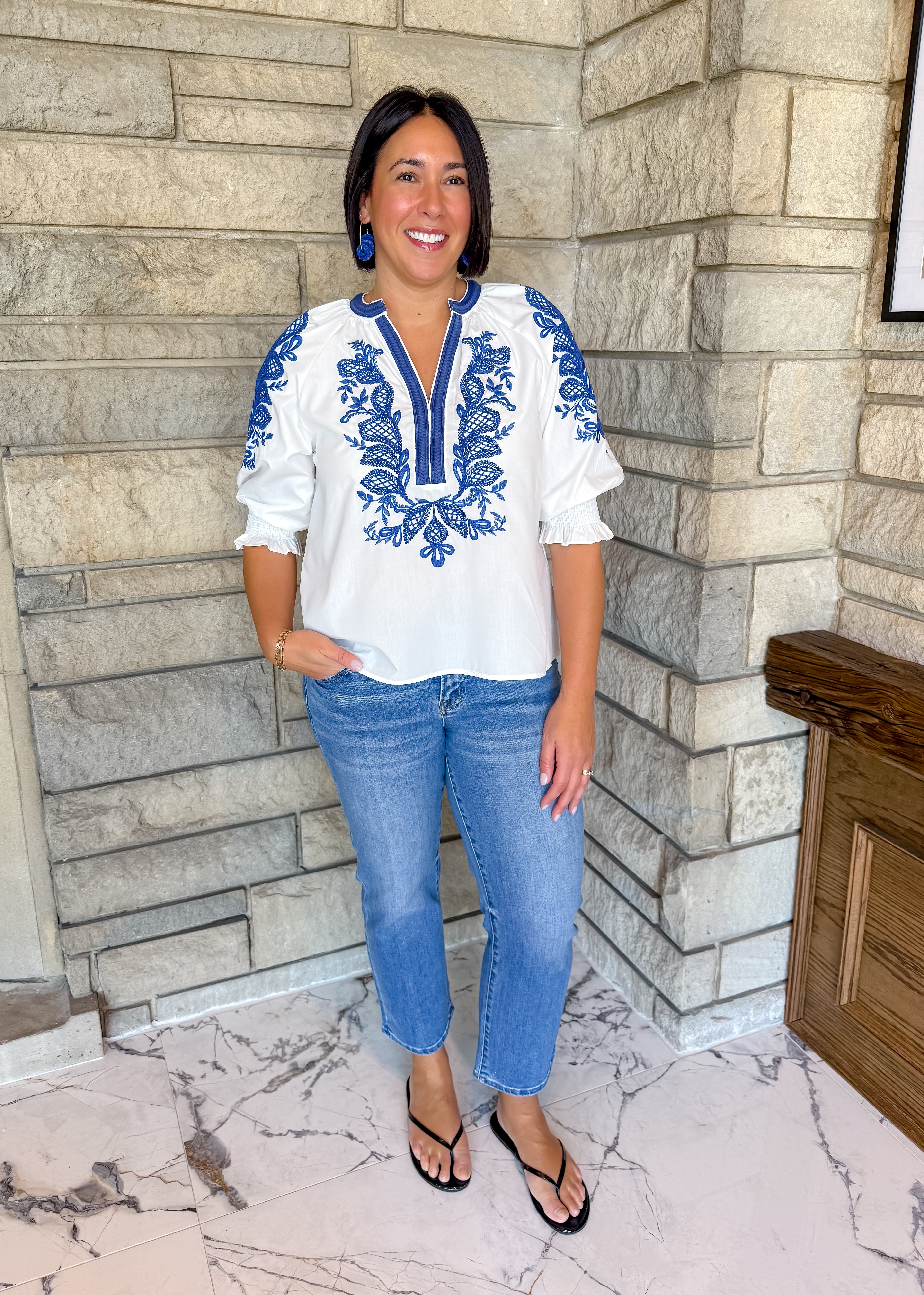 white blouse with royal blue rope trim contrast
embroidered design on front and sleeves