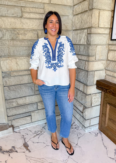 white blouse with royal blue rope trim contrast
embroidered design on front and sleeves