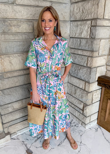 Light pink with bright floral print button front midi dress. Collared neckline short sleeve tie waist belt long dress.