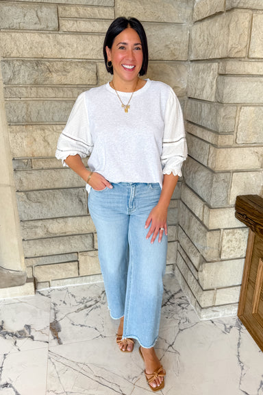 Grey top with white sleeves. Grey sweatshirt with white swiss dot sleeves. 