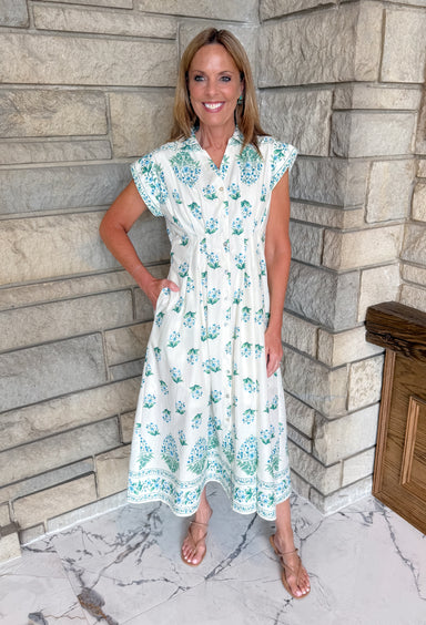 Cream dress with blue and green flowers.
Button front collar midi dress with pintucking pleats
