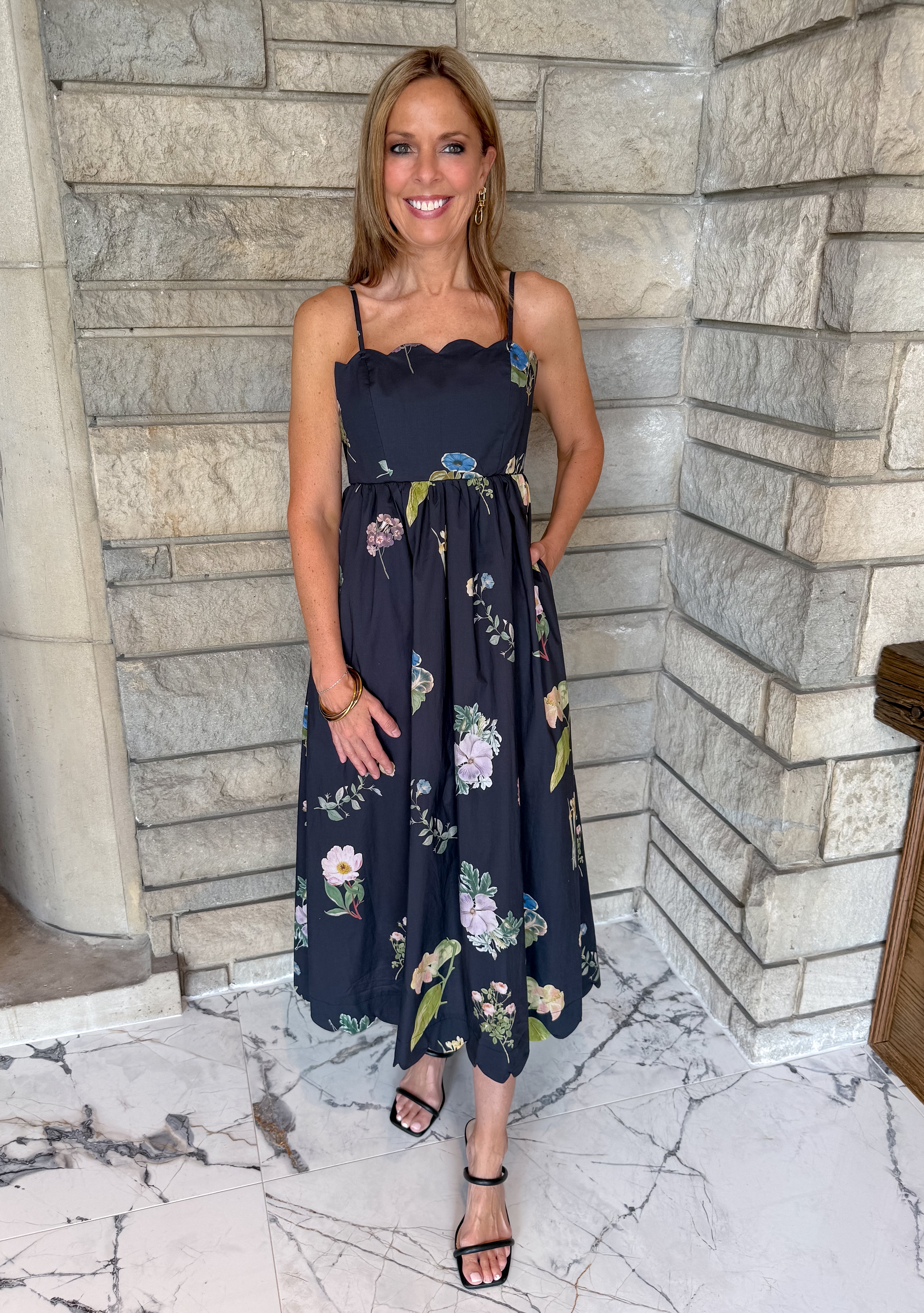 black dress with flower print
scallop neckline 
thin straps
midi length
open back with tie