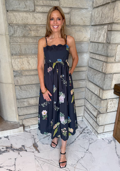 black dress with flower print
scallop neckline 
thin straps
midi length
open back with tie