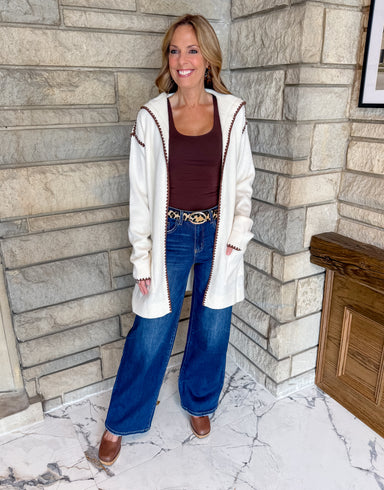Cream open cardigan with brown ric rac trim hoodie and patch pockets