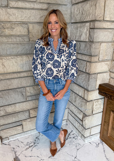 natural color background top with navy flowers and striped collar and trim 3/4 sleeves and mini ruffle stand collar