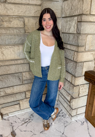 Dark sage color open chunky knit cardigan with off white large stitch detail along sleeves and patch pockets