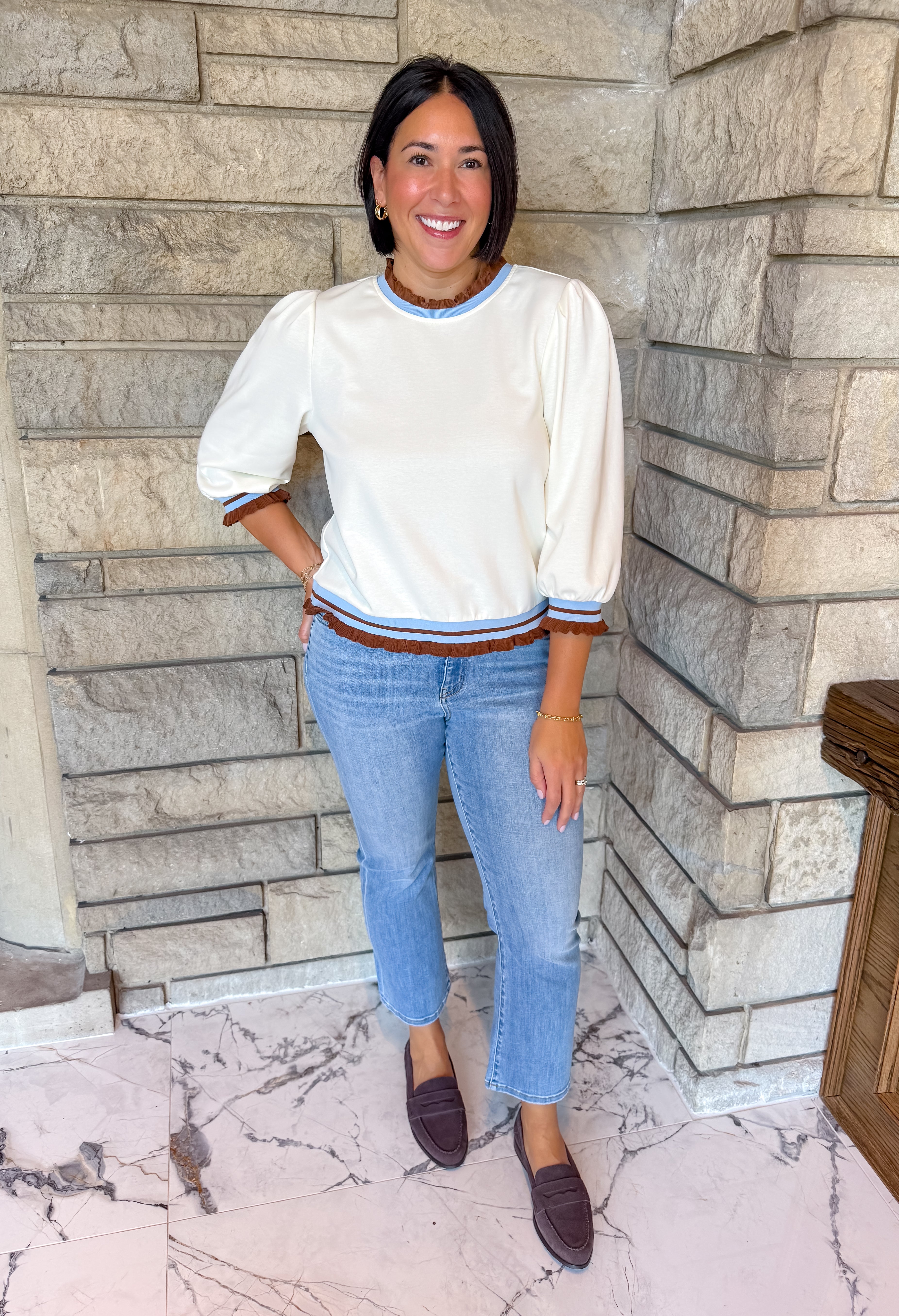 Cream top with brown and light blue striped ruffle collar, cuffs and hem, puff 3/4 sleeves