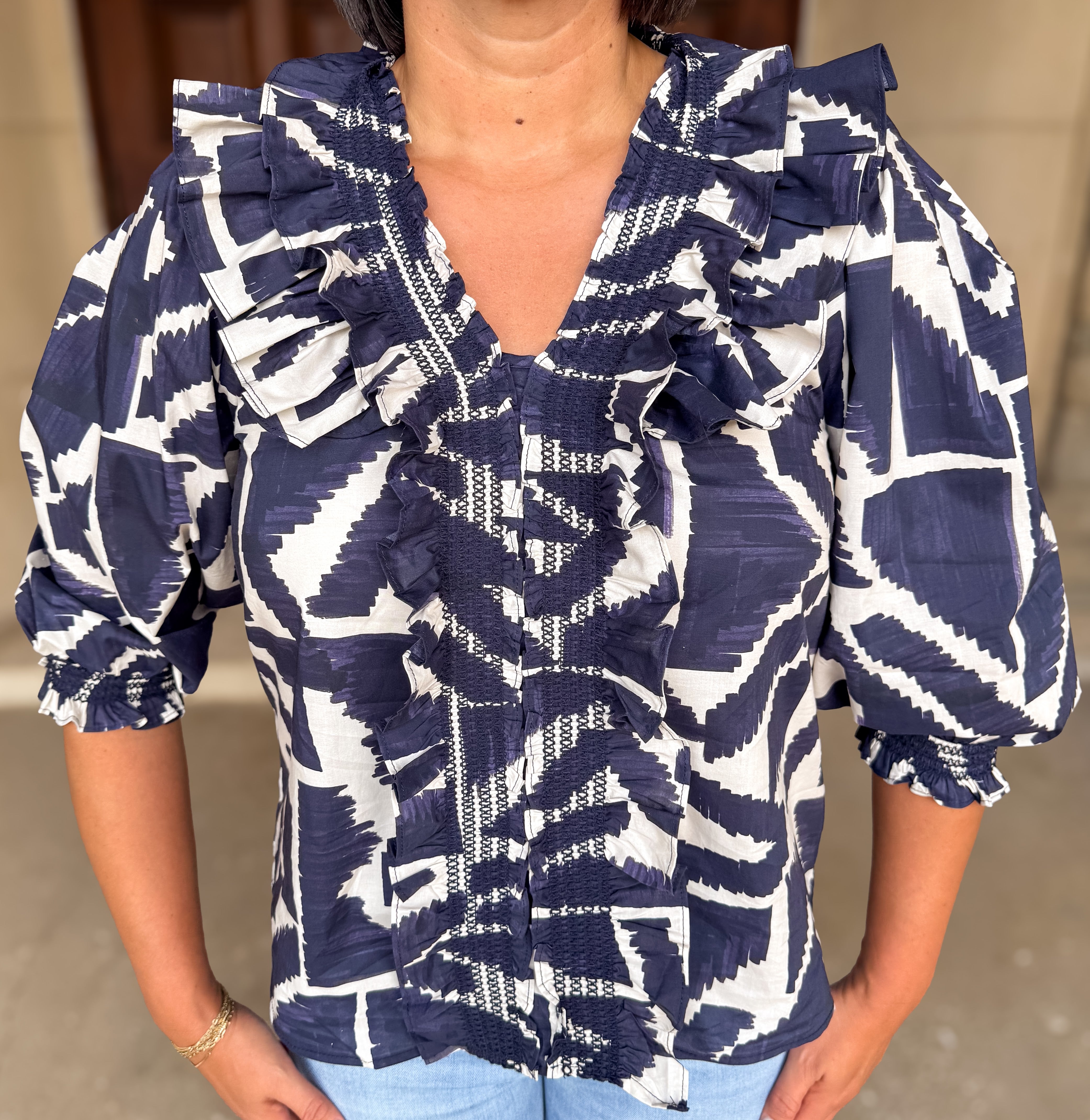 Becca Printed Smocked Ruffle Top