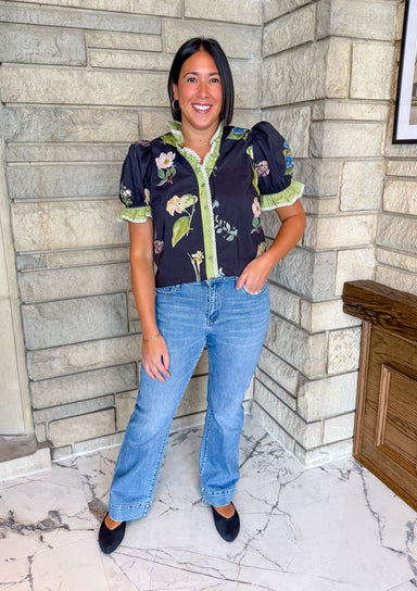 Black top with flowers
Contrast trim blouse
Ruffle trim top
Puff sleeve stop
Button front top