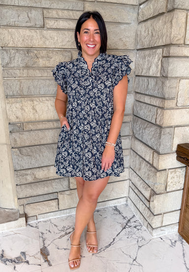 Navy dress with natural color flower print and ruffles