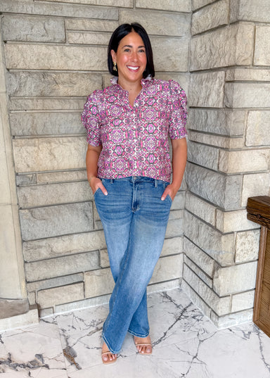 Pink Multi colored printed button top with puff sleeves and ruffle collar.