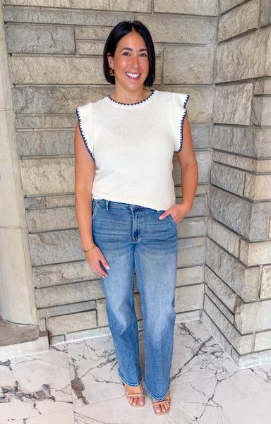 Ivory sleeveless ruffle top with navy scallop trim. Lightweight summer sweater tank with ruffle.