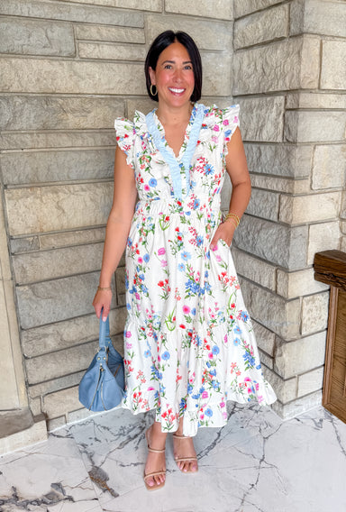 Cream midi dress with bright flowers
light blue ruffle trim
ruffle sleeves
smocked waist
