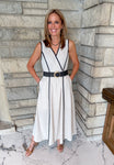 natural color dress with black trim
black trim detail
black woven belt with gold buckle