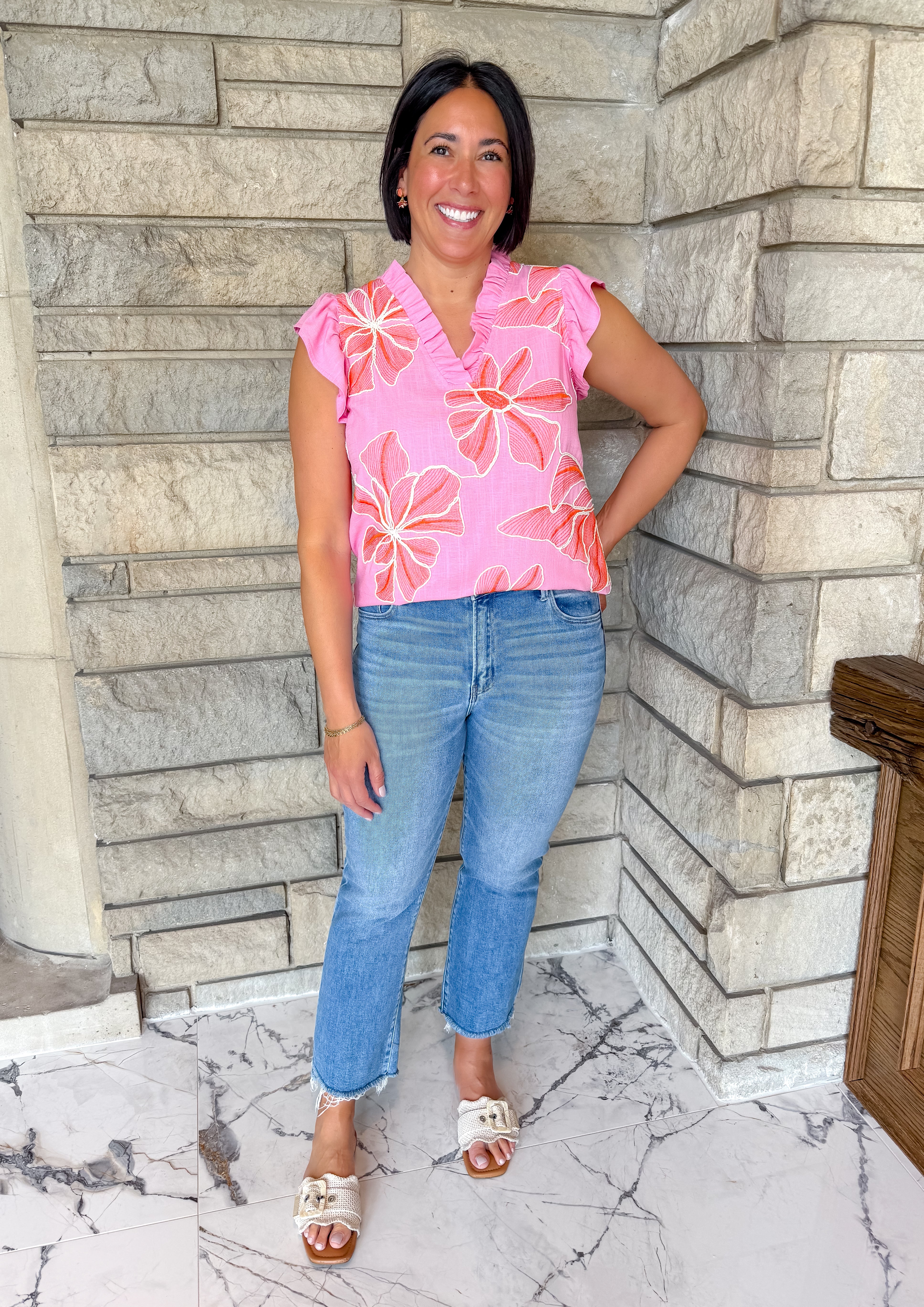 light pink sleeveless top with coral and white flowers
ruffle sleeves and neck sleeveless flower top