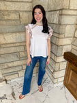 White top with  brown embroidered ruffles