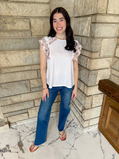 White top with  brown embroidered ruffles