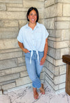 Light blue and white vertical striped top
tie waist
buttons
front pocket
fixed rolled sleeves