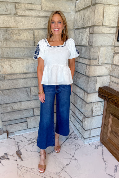 white peplum top puff sleeves navy embroidery