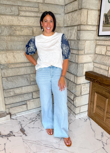 white tshirt with navy puff sleeves floral embroidery