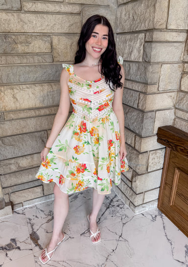 white dress with reds and orange and green flowers pintuck pleating ruffle sleeves