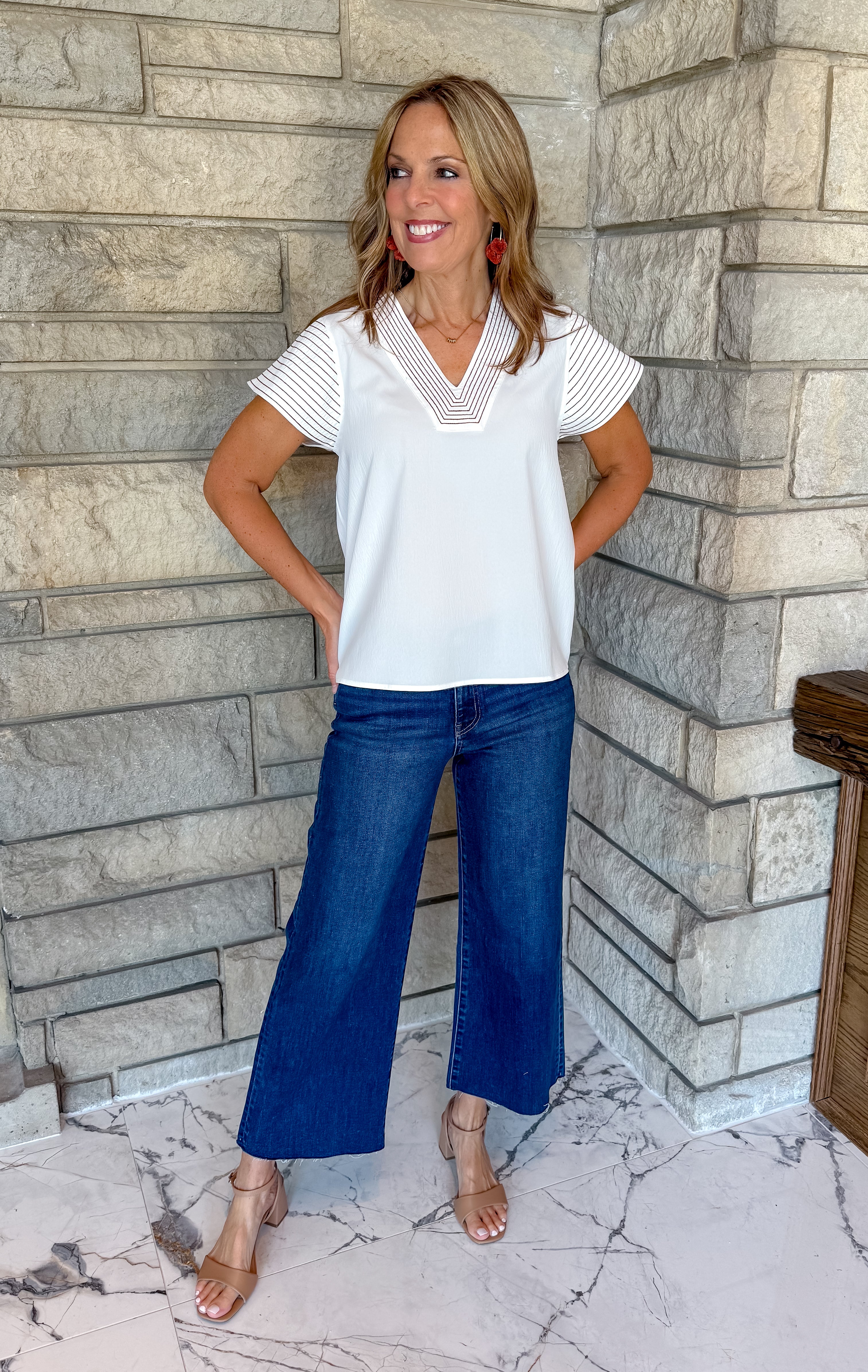 White v neck blouse with contrast brown stitching on sleeves and neckline