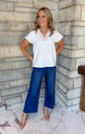 White v neck blouse with contrast brown stitching on sleeves and neckline