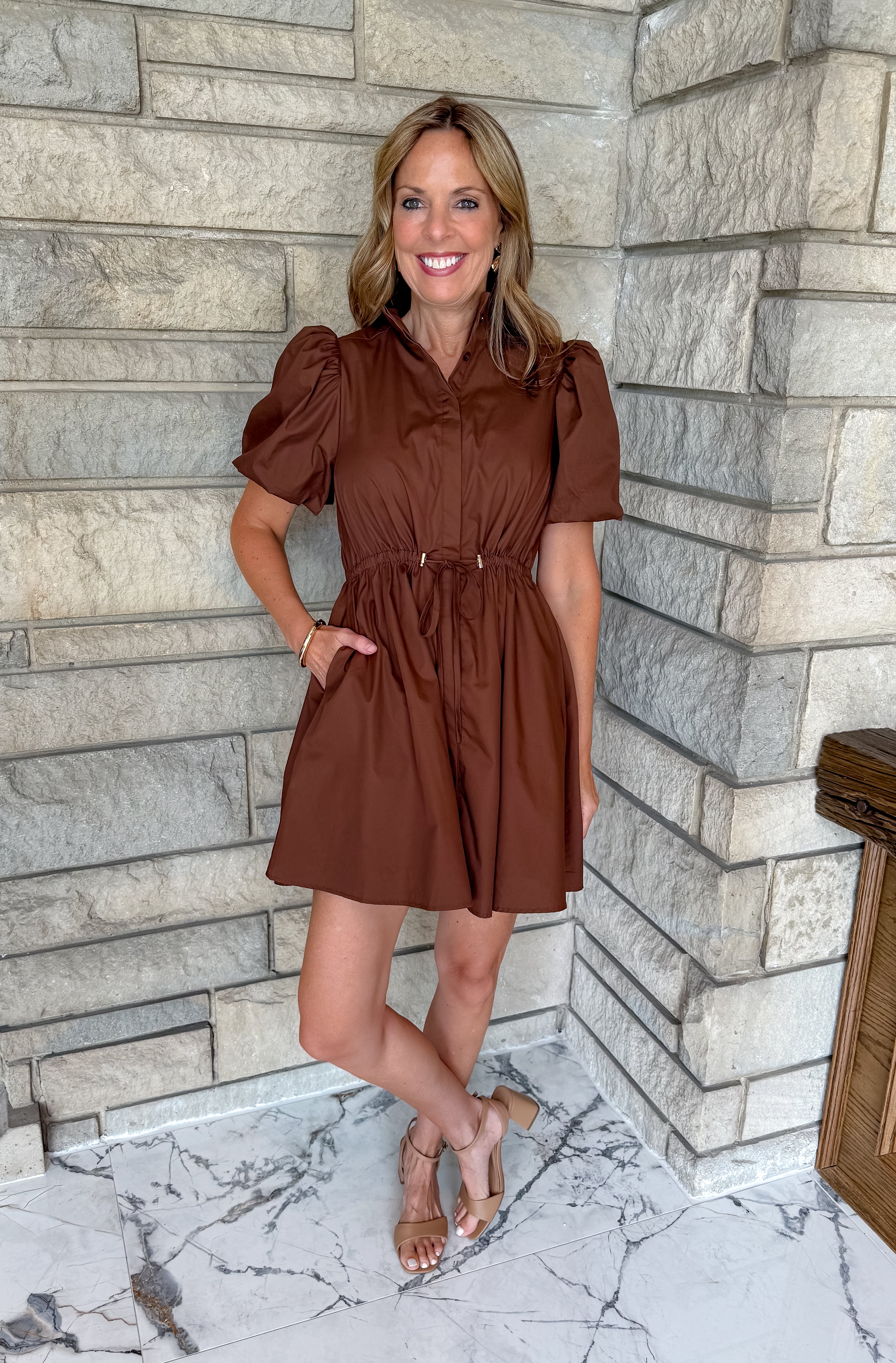 brown puff sleeve dress with collar and buttons and cinched waist with gold toggles short length