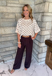 Brown slim wide leg dress pants with pleats and tan belt